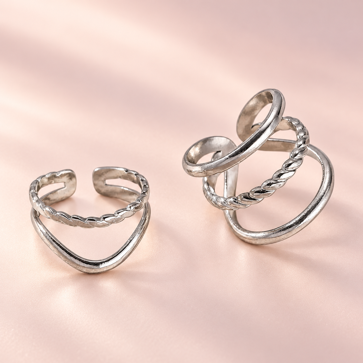 Silver-Tone Layered Ring Designs on a softly coloured background