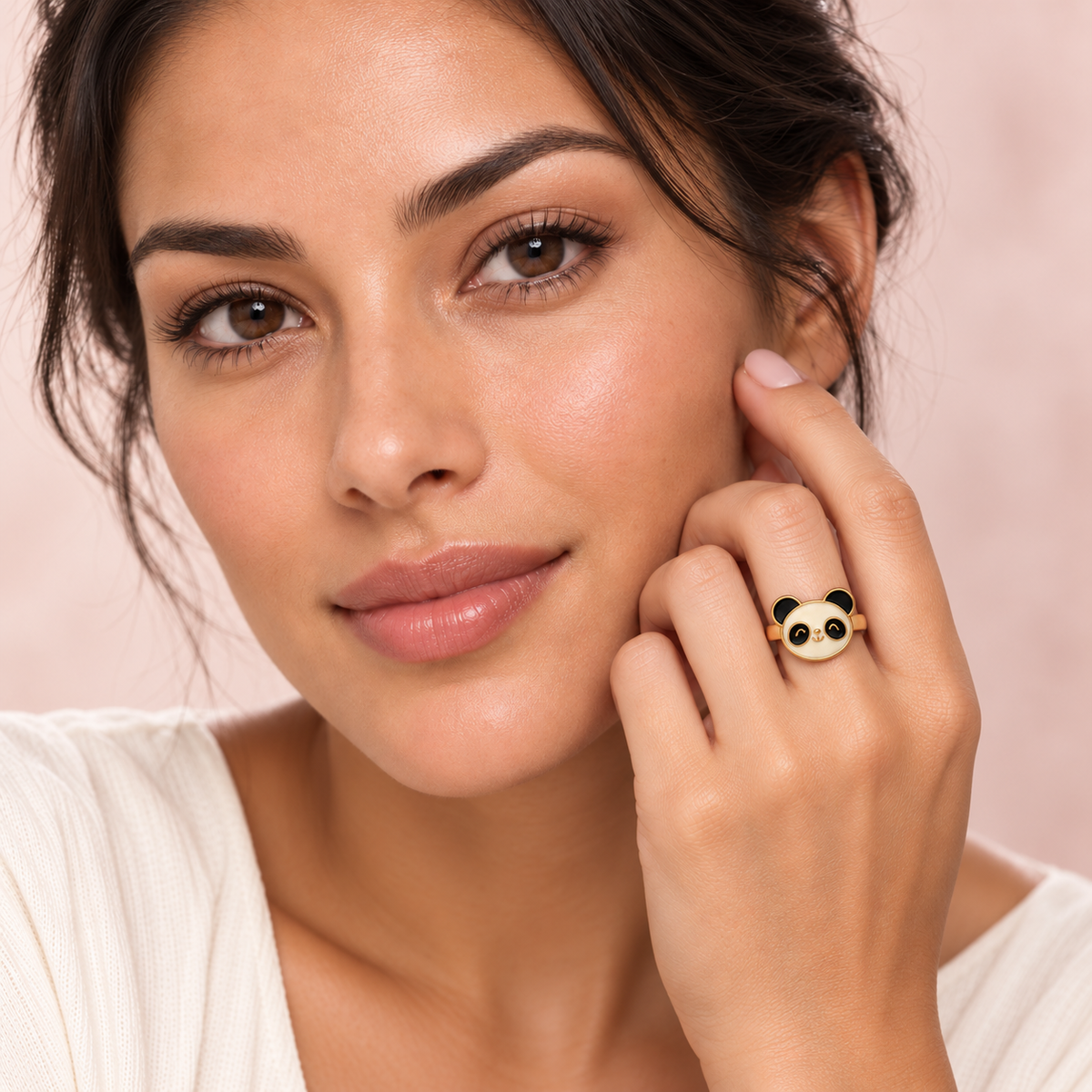 Black-and-white panda face ring with gold-tone band styled on a hand