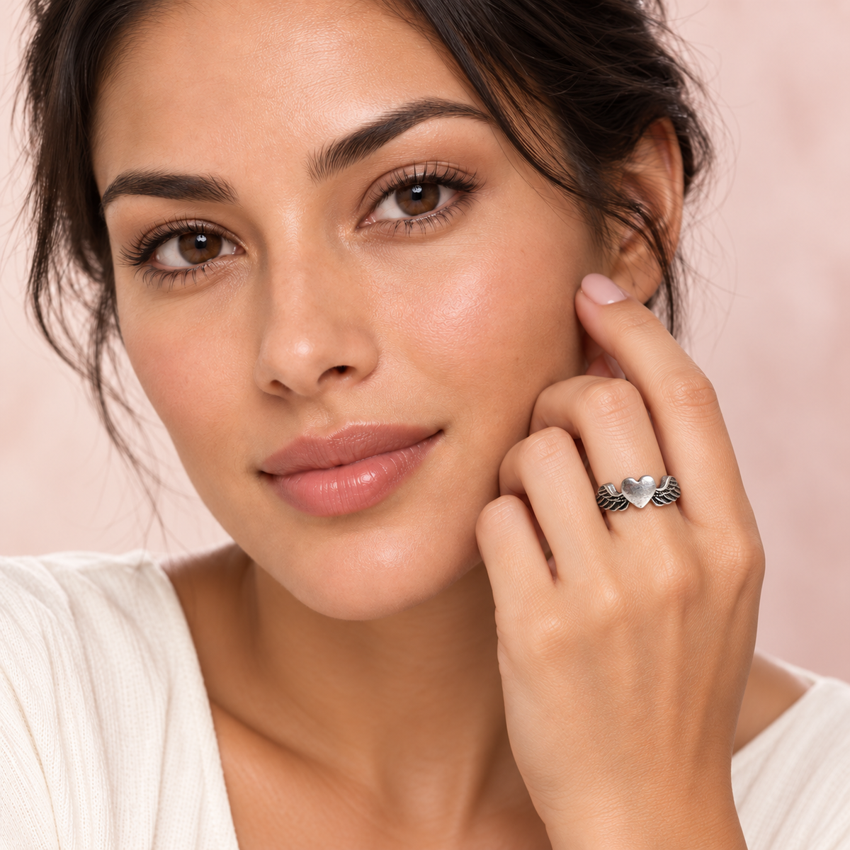 Silver-Tone Winged Heart Ring worn on a hand