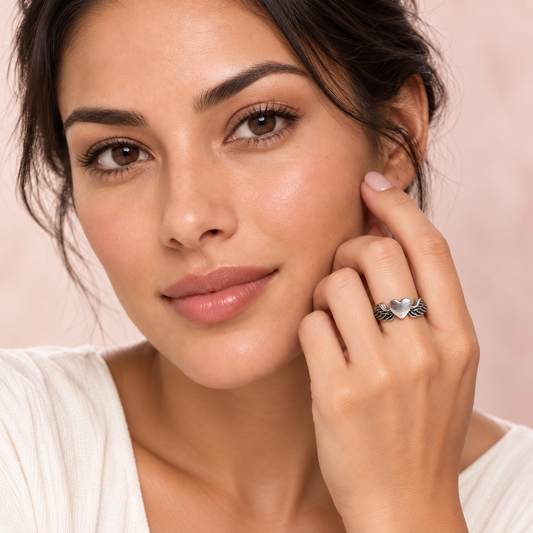 Silver-Tone Winged Heart Ring worn on a hand