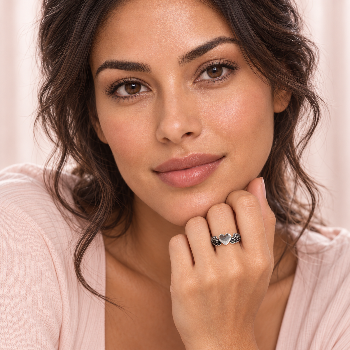 Silver-Tone Winged Heart Ring worn on a hand