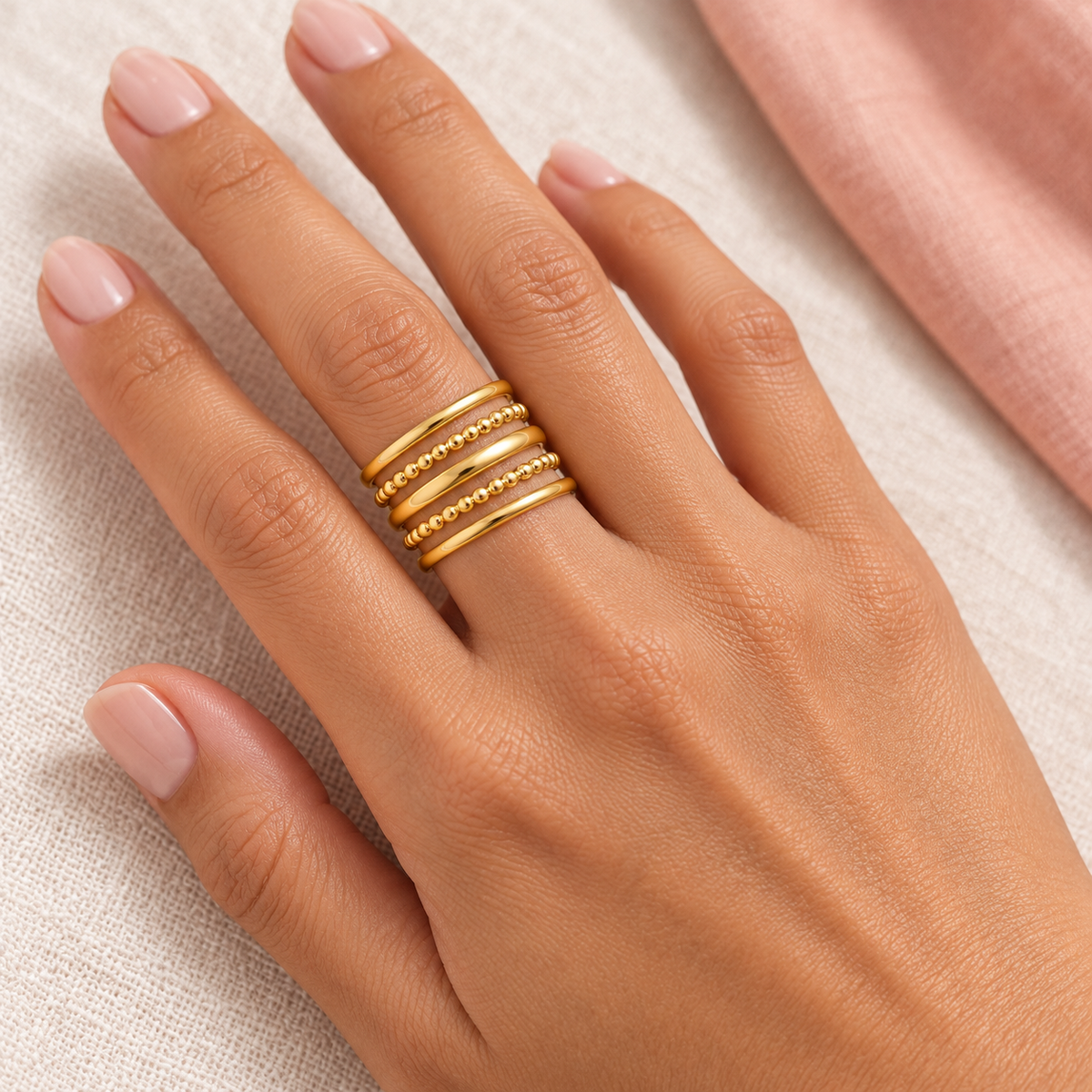 Gold-tone multi-row ring with two beaded rows styled on a hand