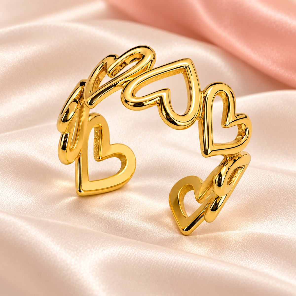 Gold-tone open ring with linked heart outlines