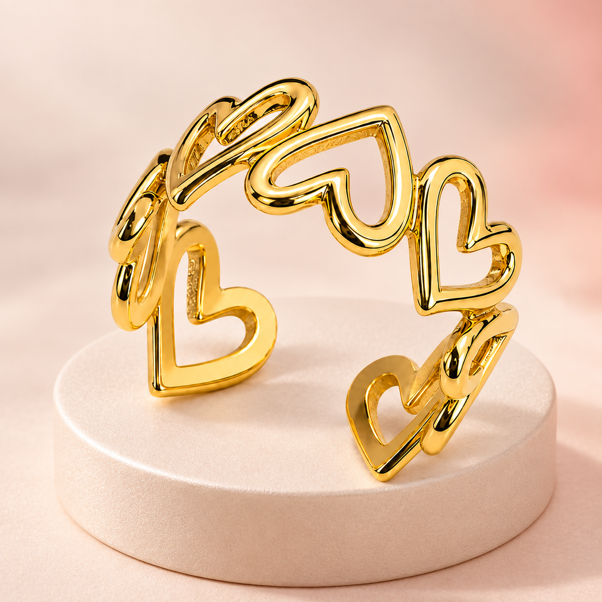 Gold-tone open ring with linked heart outlines