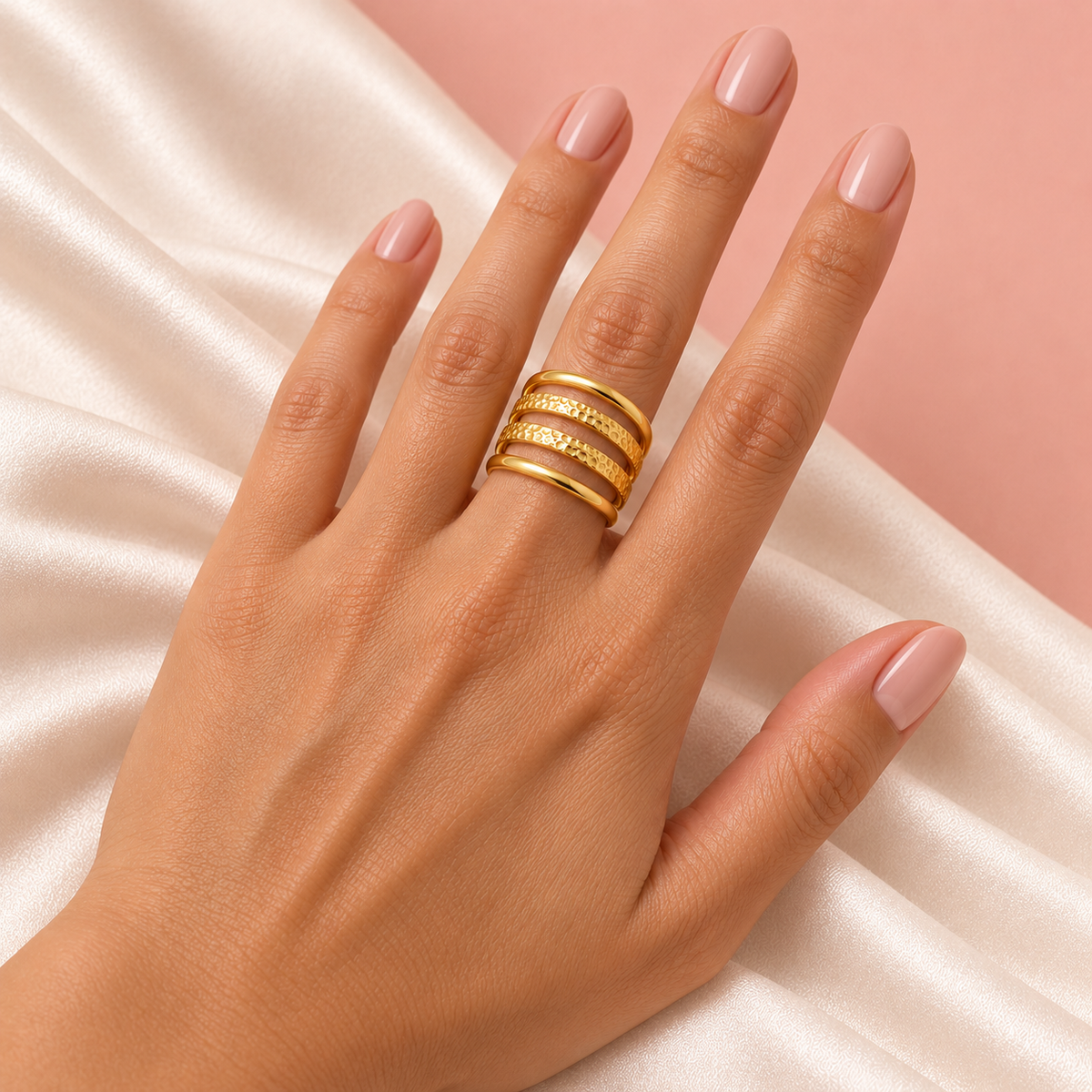 Hammered Four-Rail Ring worn on a hand over cream satin
