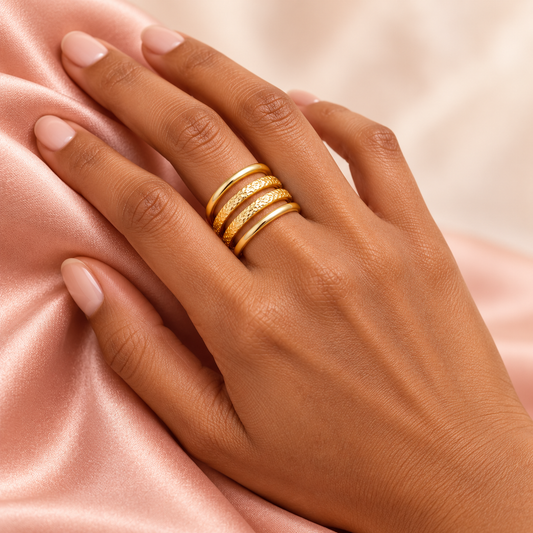 Hammered Four-Rail Ring worn on a hand over pink satin