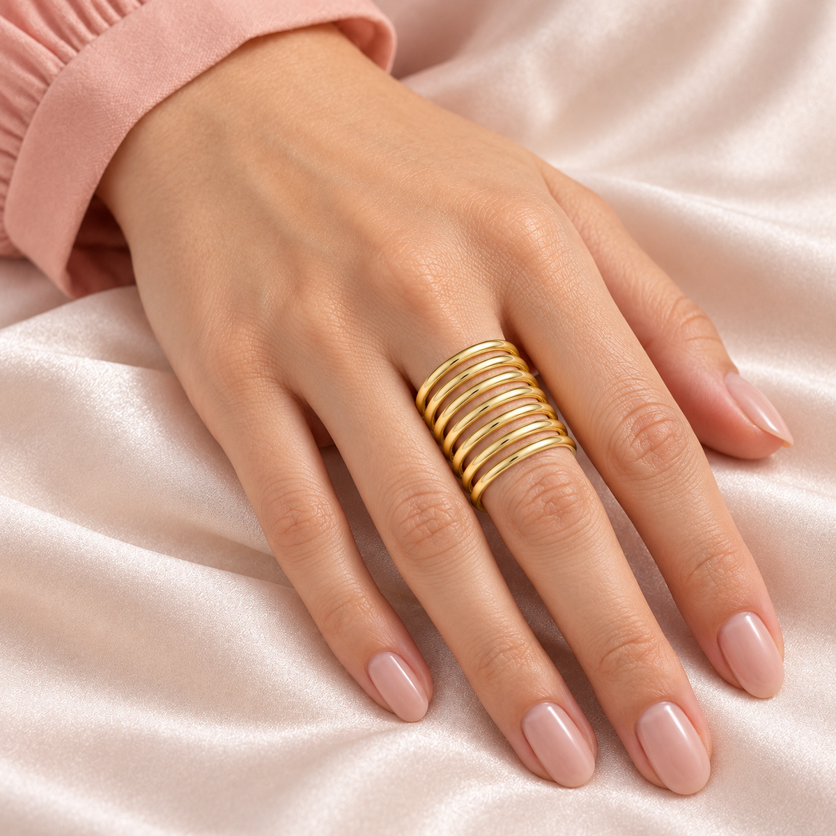 Seven-Rail Open Ring worn on a hand over satin
