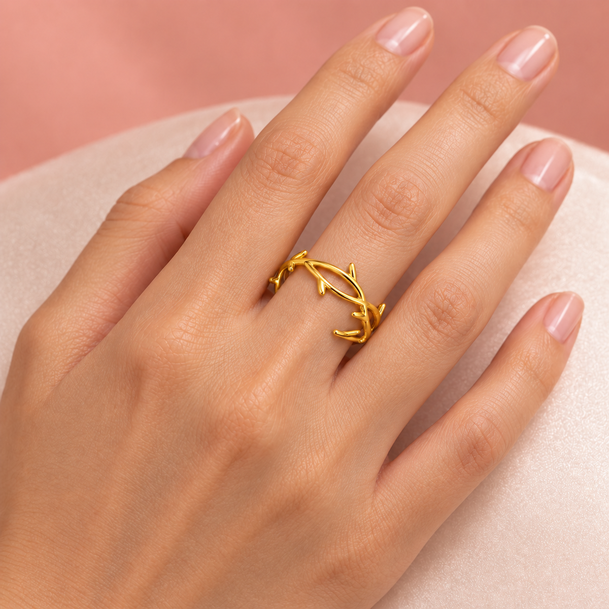 Gold-tone open ring with a twig-like design styled on a hand