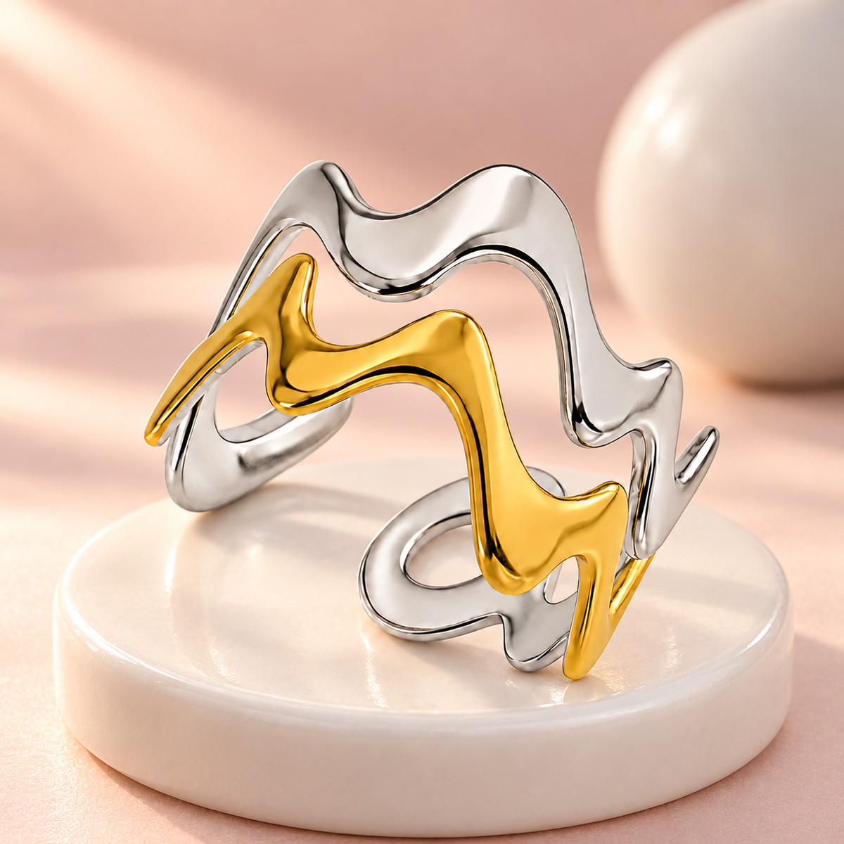 Two-tone wavy ring, still-life view on fabric.