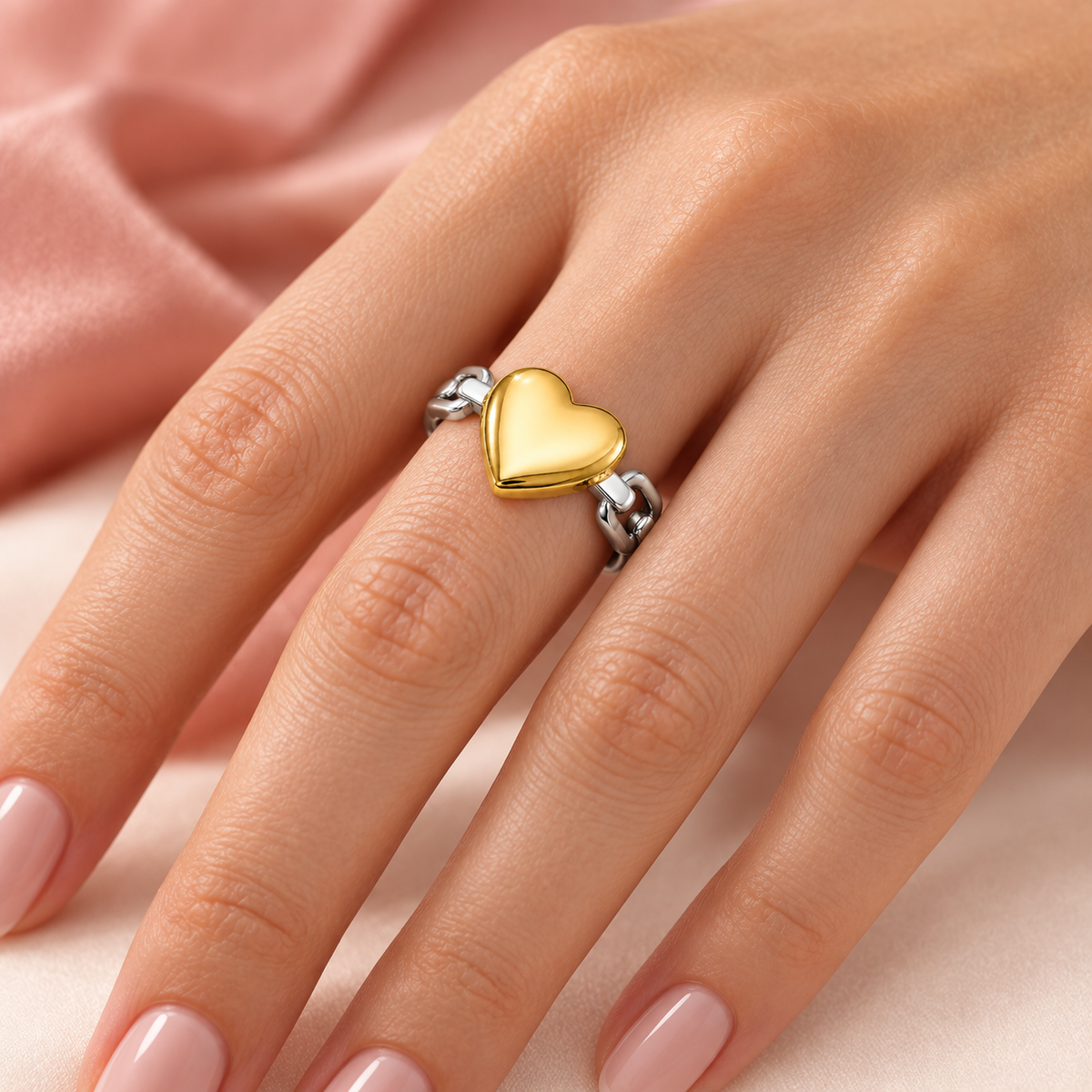 Two-tone open ring with a gold-tone heart and silver-tone link band styled on a hand