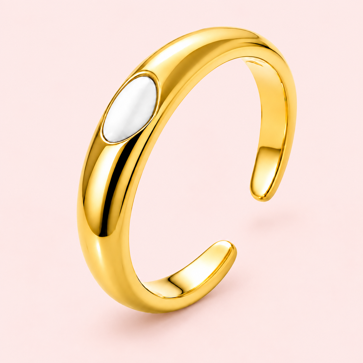 Gold-tone ring with white oval detail, detail view.