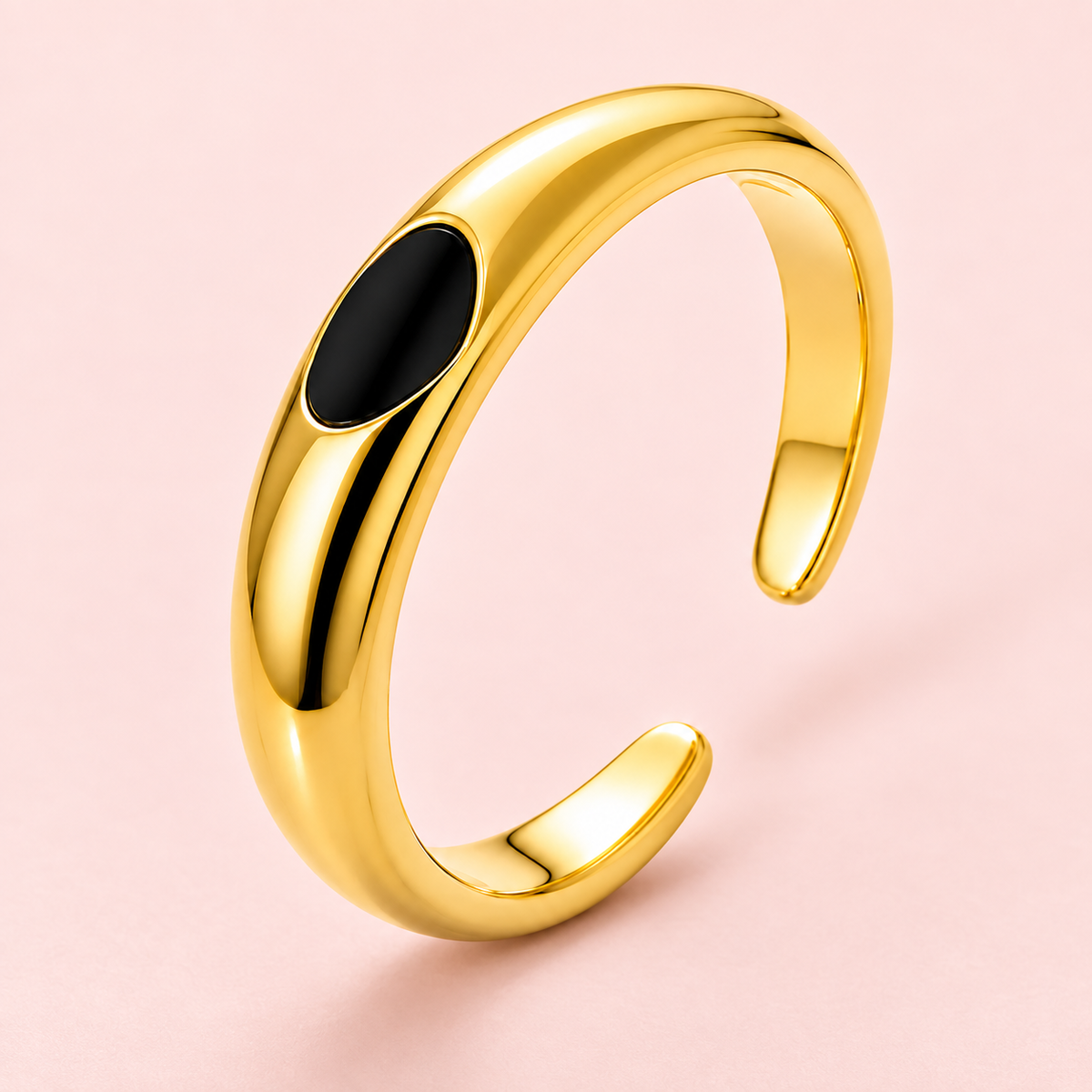 Gold-tone ring with black oval detail, detail view.
