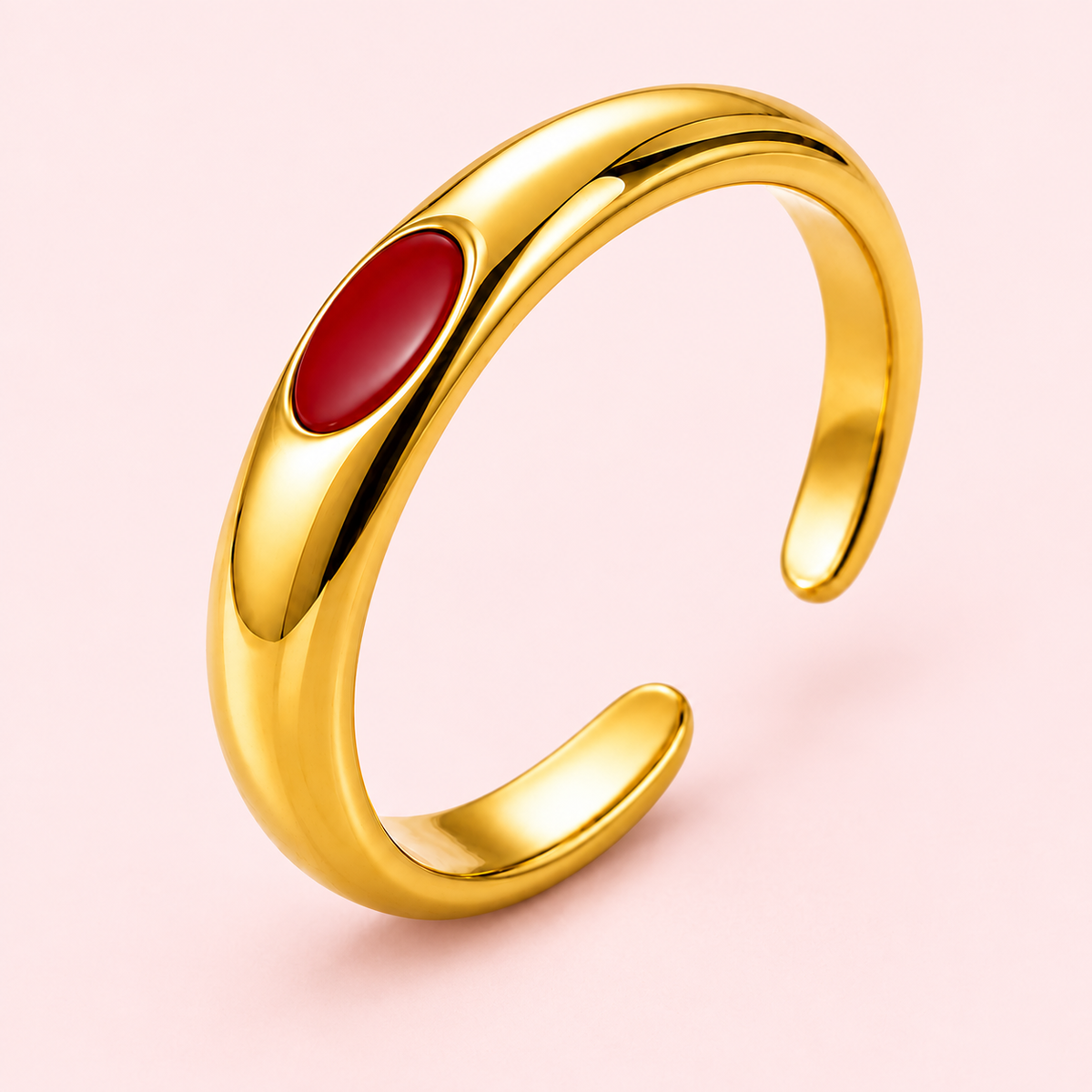 Gold-tone ring with red oval detail, detail view.