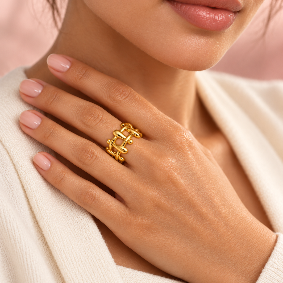 Gold-tone sculptural lattice ring, shown on a hand.