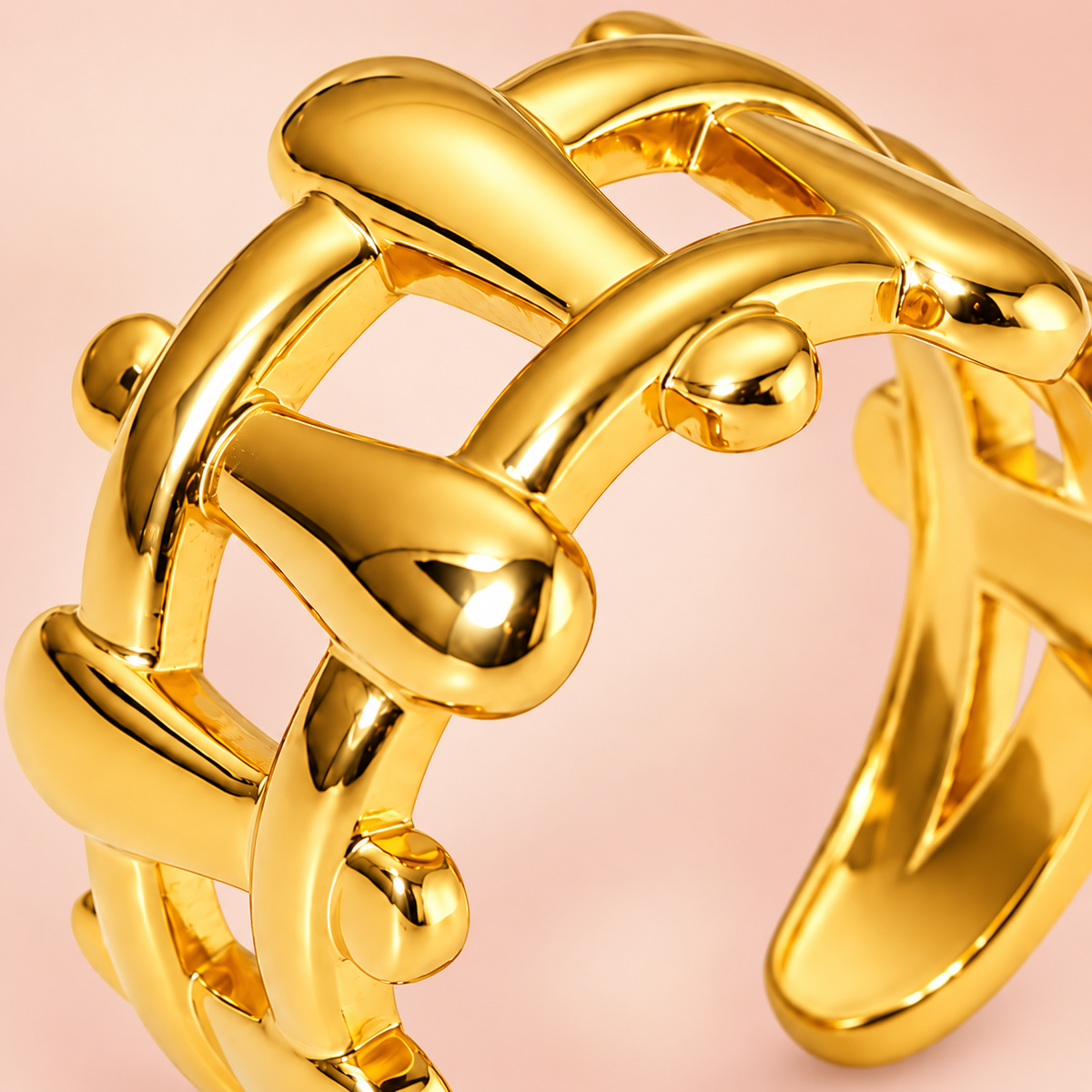 Gold-tone sculptural lattice ring, close-up view.
