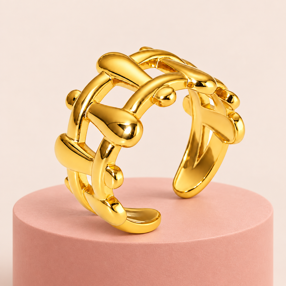 Gold-tone sculptural lattice ring, styled product view.