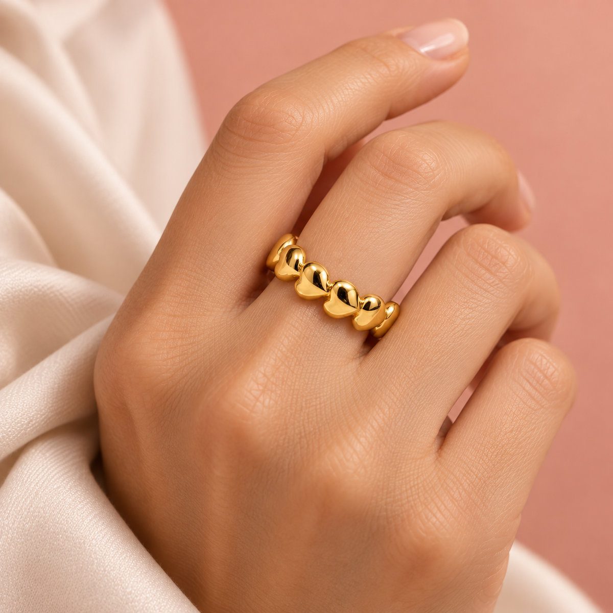 Gold-tone heart chain ring, shown on a hand from another angle.