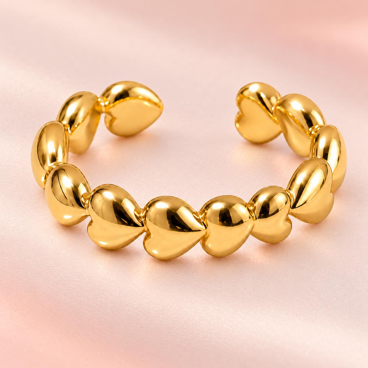 Gold-tone heart chain ring, close-up view.