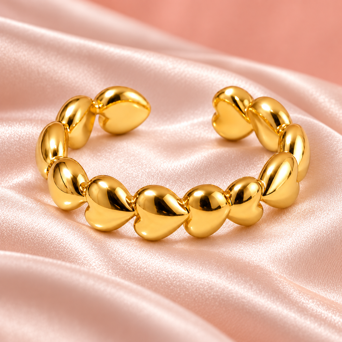 Gold-tone heart chain ring, still-life view on fabric.