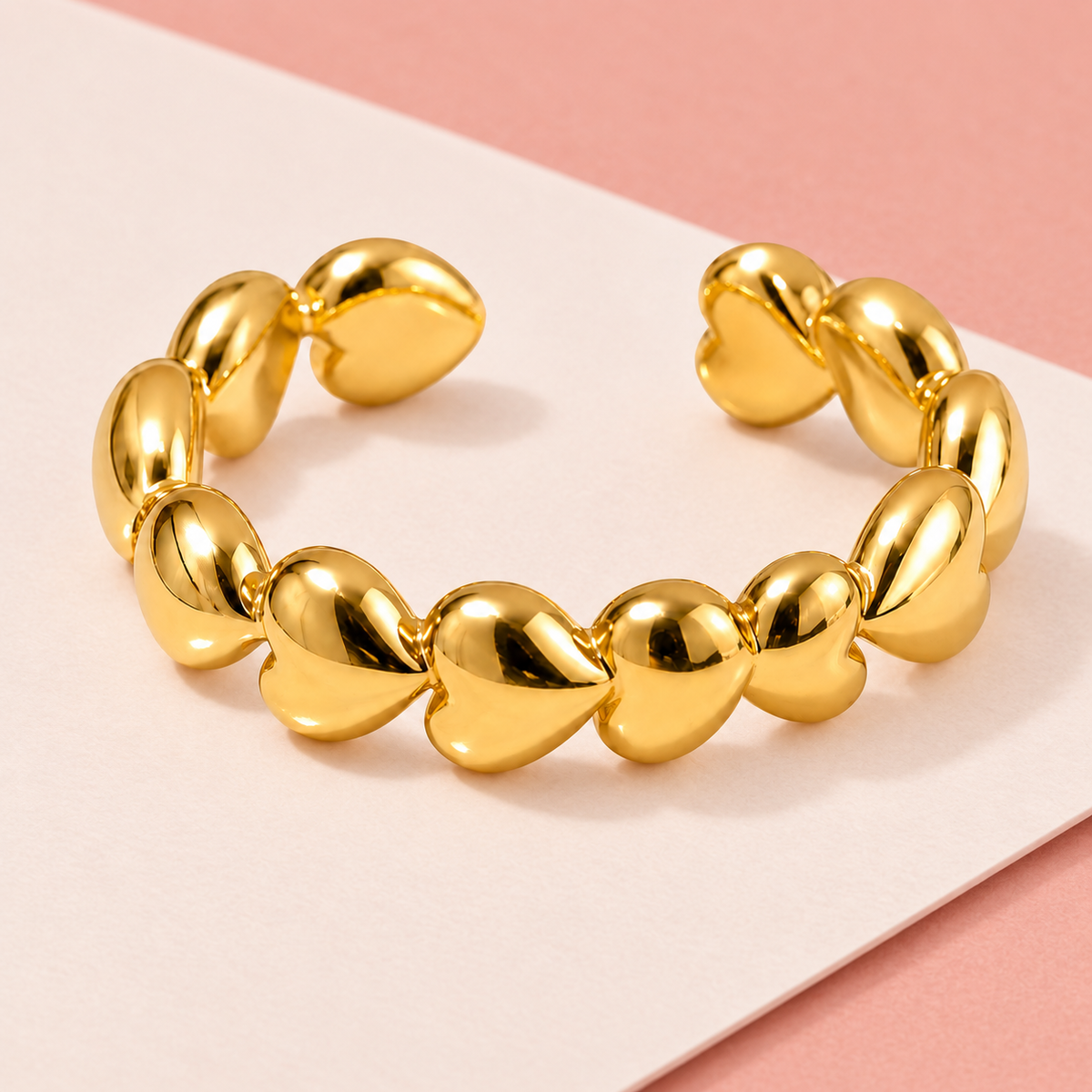Gold-tone heart chain ring, styled product view.