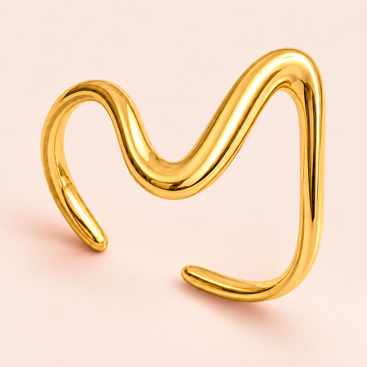 Gold-tone asymmetric wave ring, close-up view.
