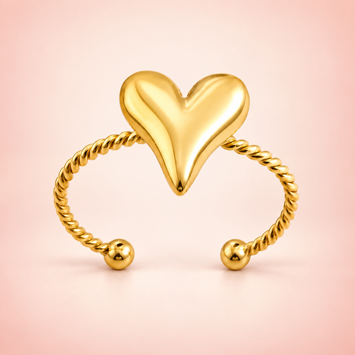 Gold-tone heart and rope ring, product view.