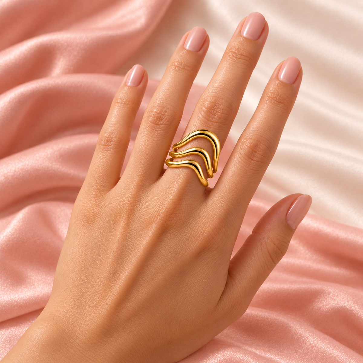 Gold-tone triple wave ring, shown on a hand.