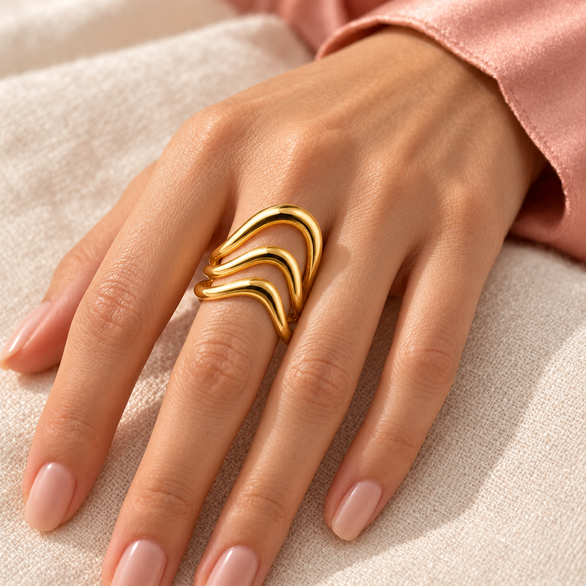 Gold-tone triple wave ring, shown on a hand from another angle.
