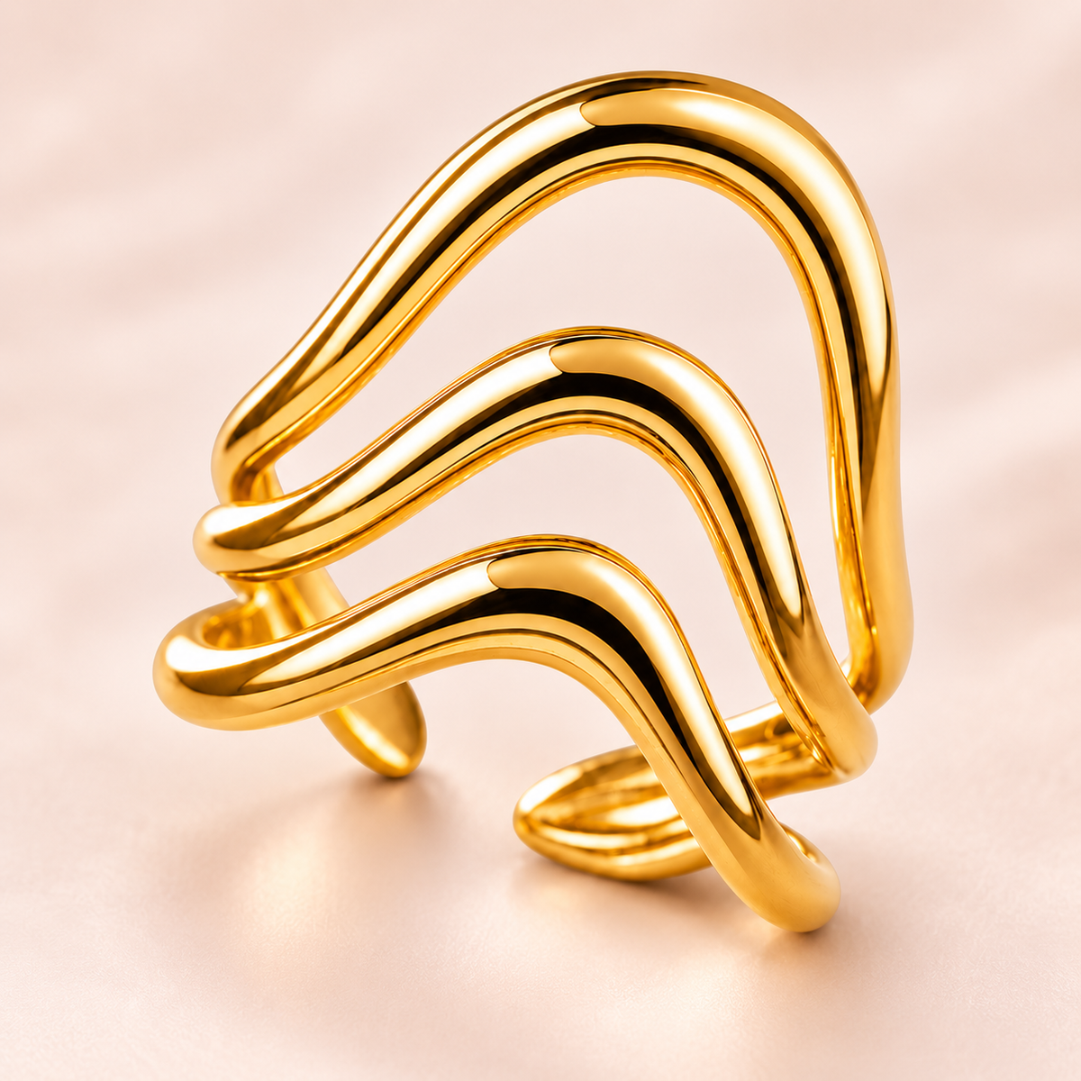 Gold-tone triple wave ring, close-up view.