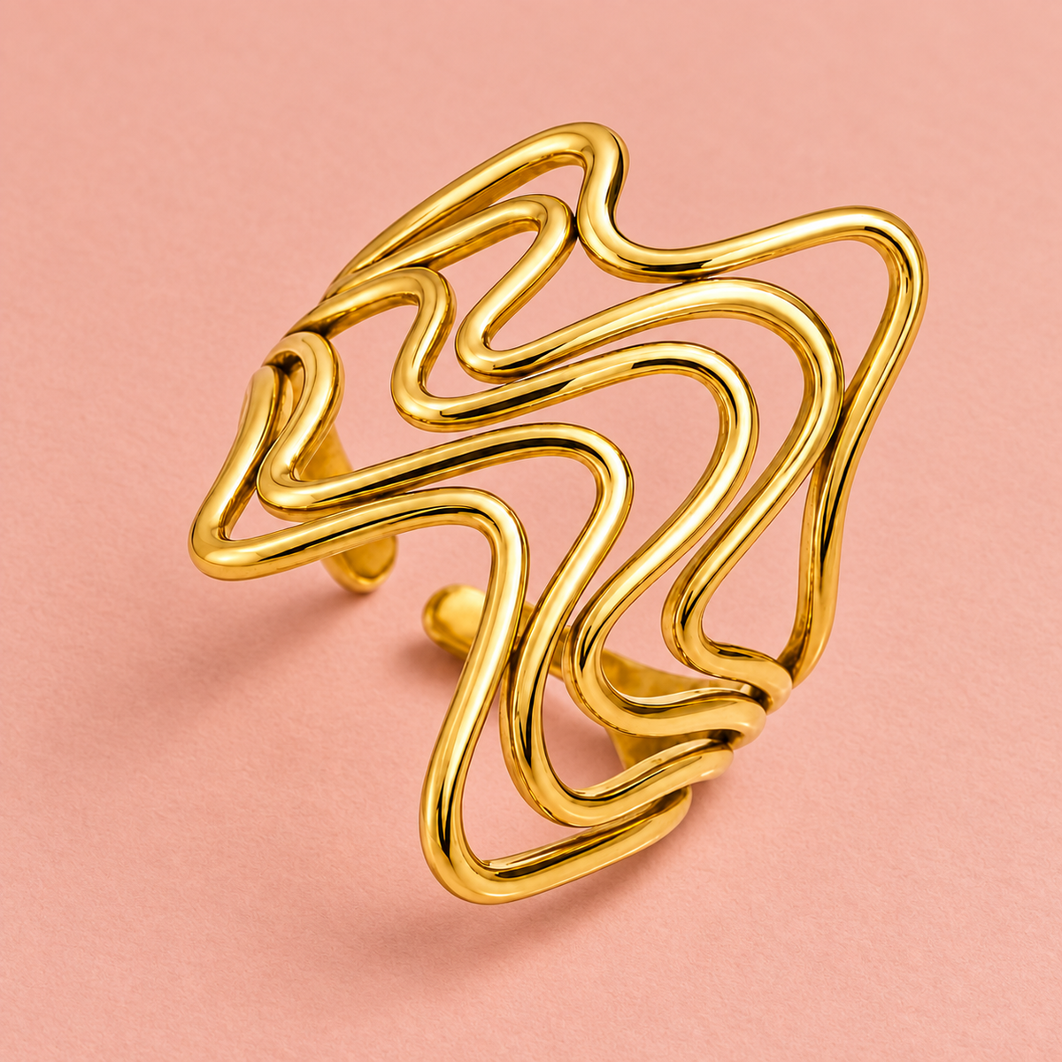 Gold-tone flowing wave ring, detail view.
