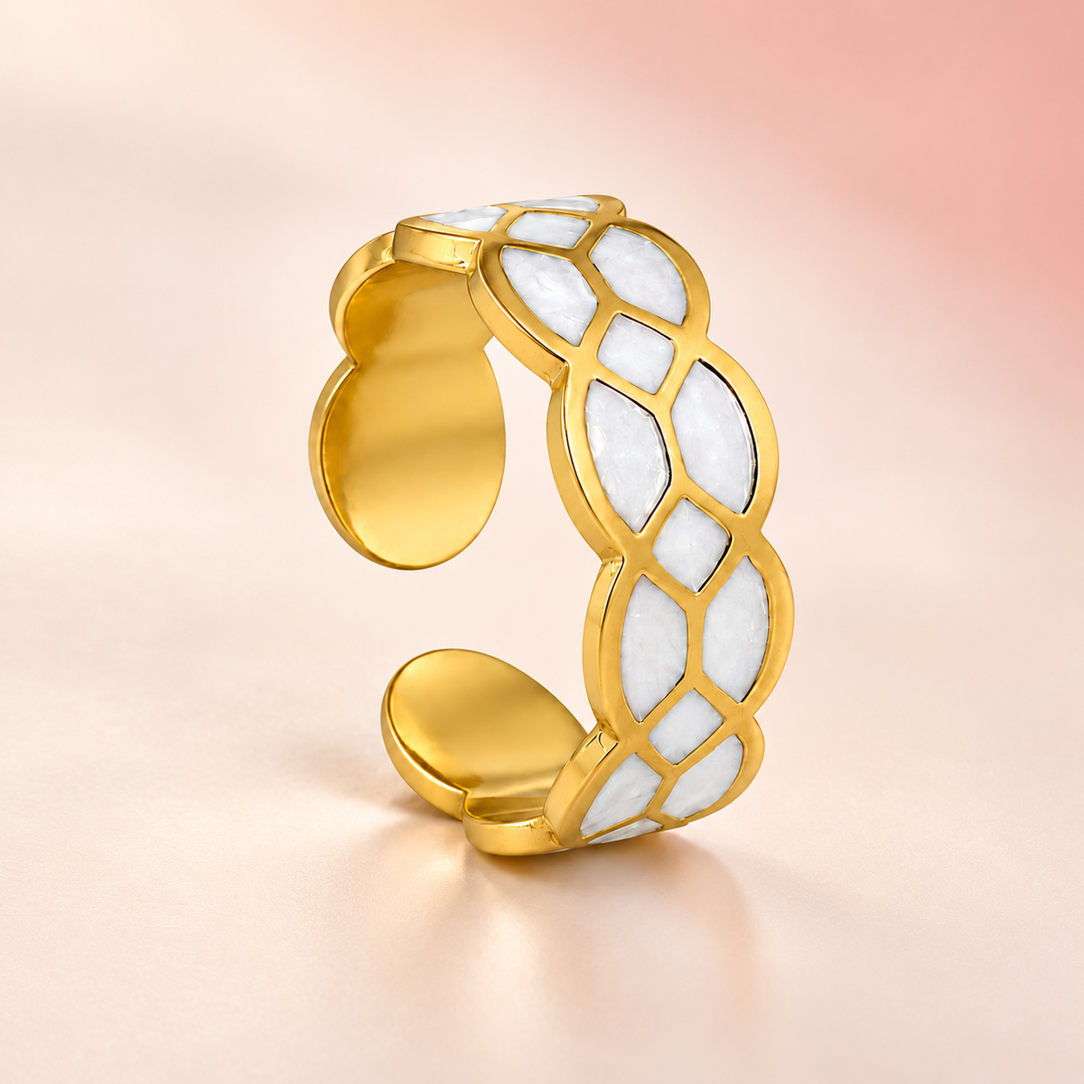 Gold-tone ring with white mosaic pattern, product view.