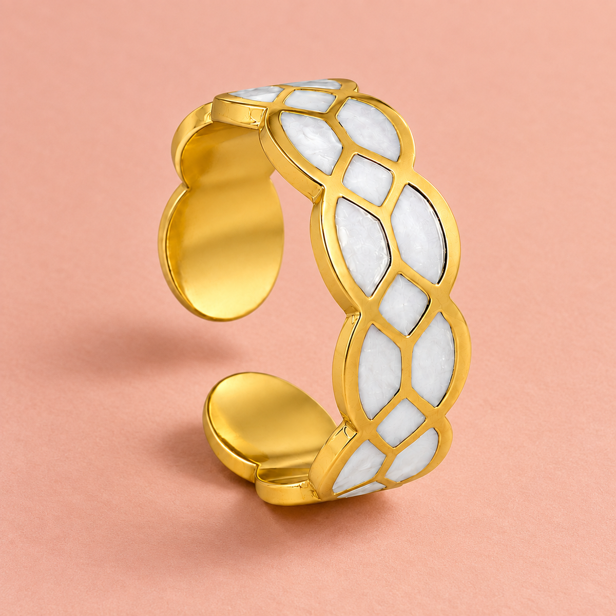 Gold-tone ring with white mosaic pattern, detail view.