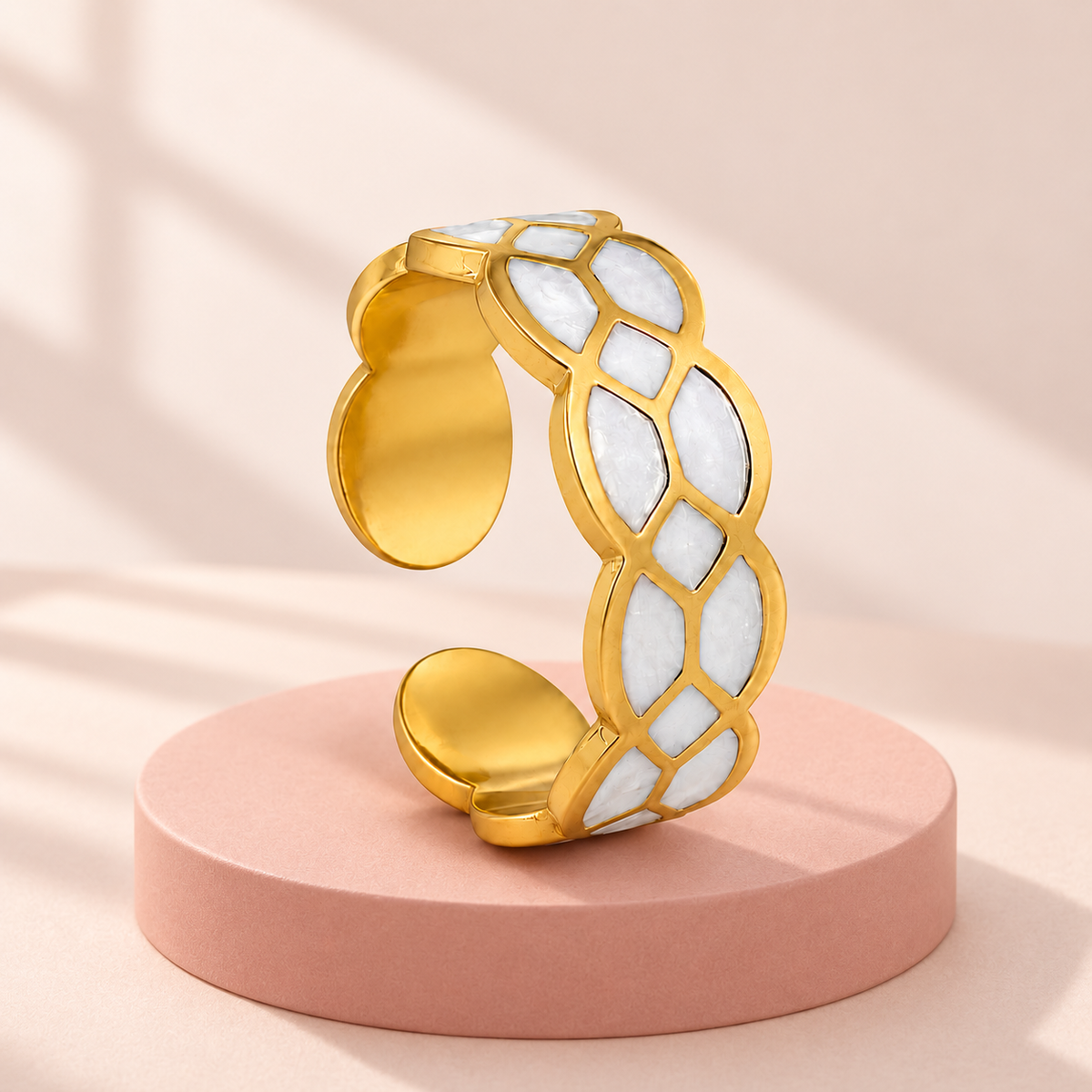 Gold-tone ring with white mosaic pattern, styled product view.
