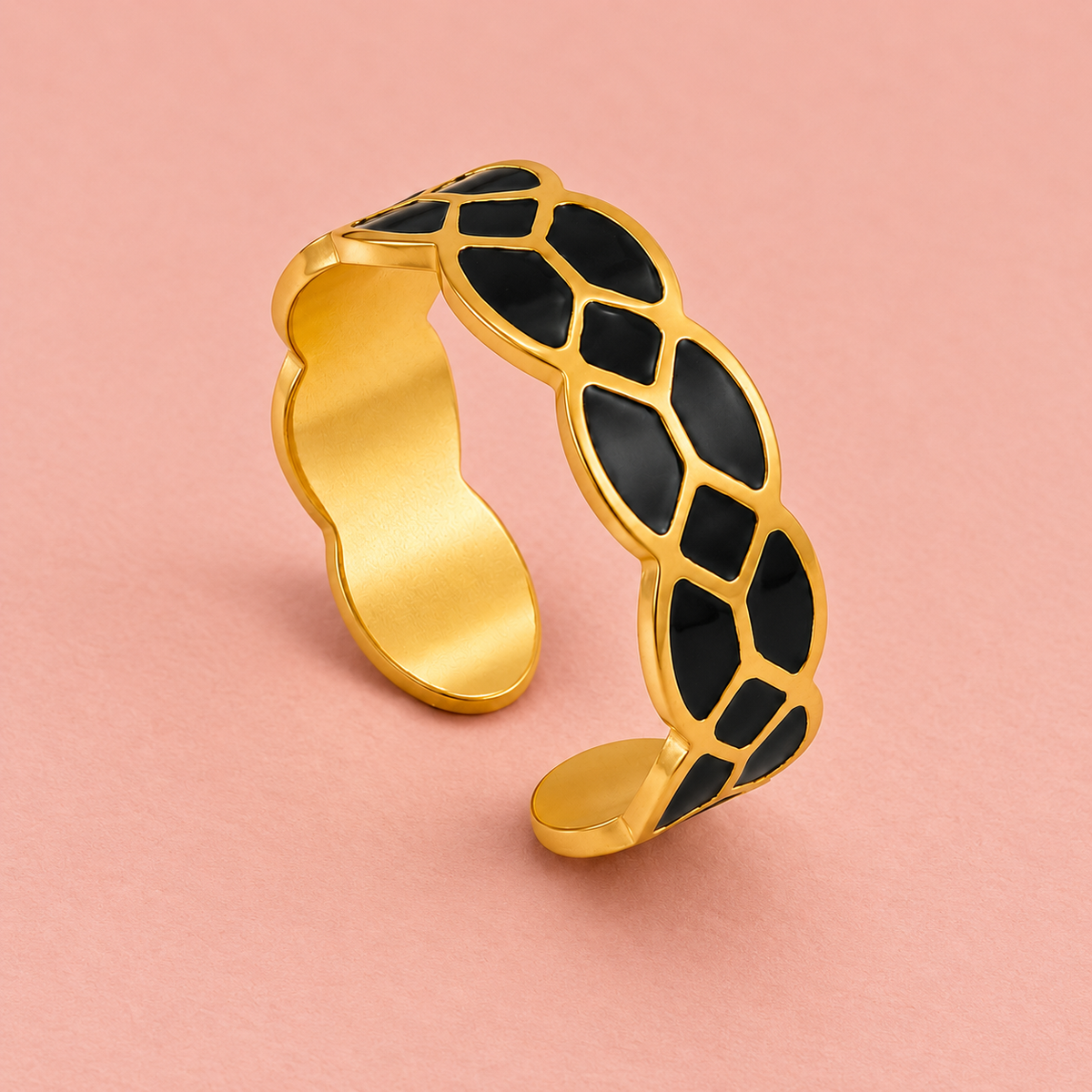 Gold-tone ring with black mosaic pattern, detail view.