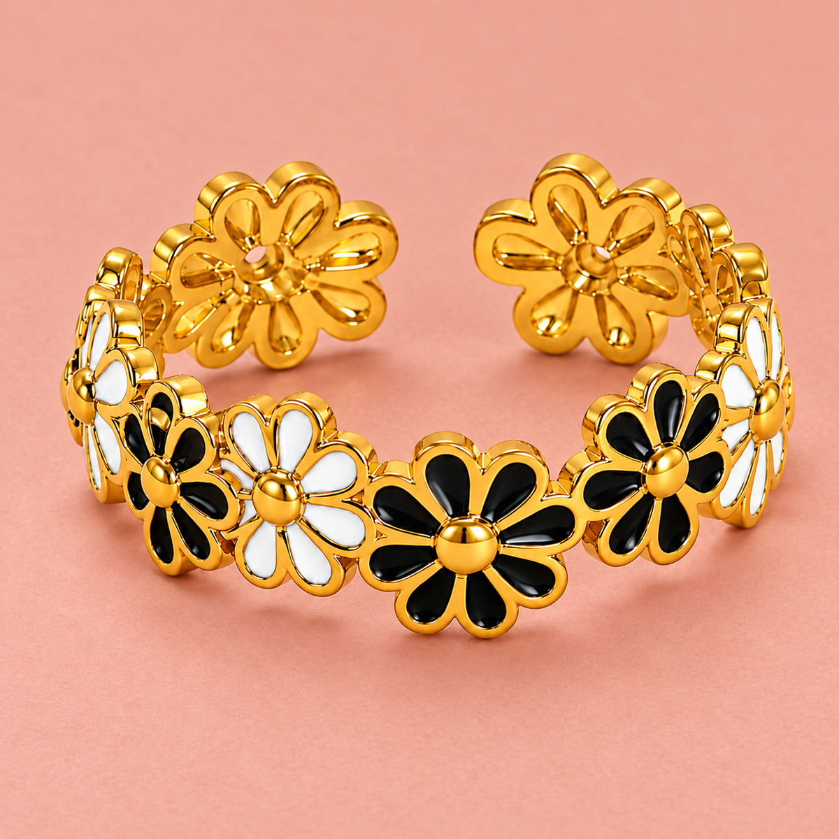 Gold-tone ring with black and white flowers, detail view.