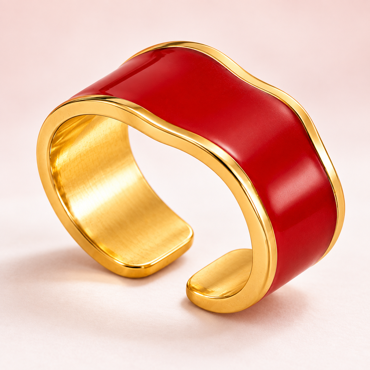 Red wave ring with gold-tone edges, detail view.