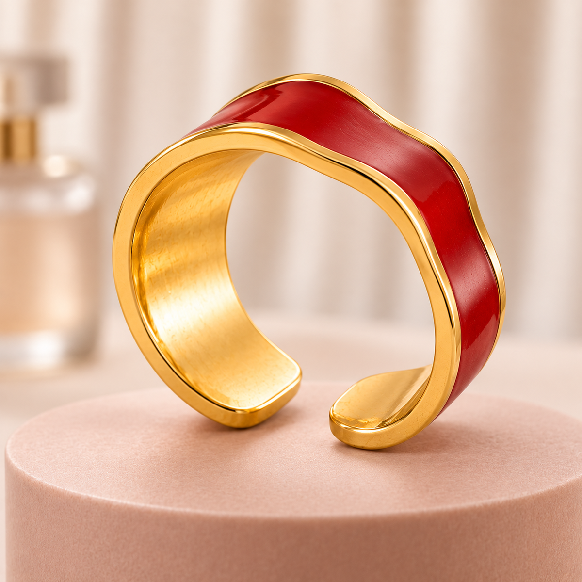 Red wave ring with gold-tone edges, styled product view.