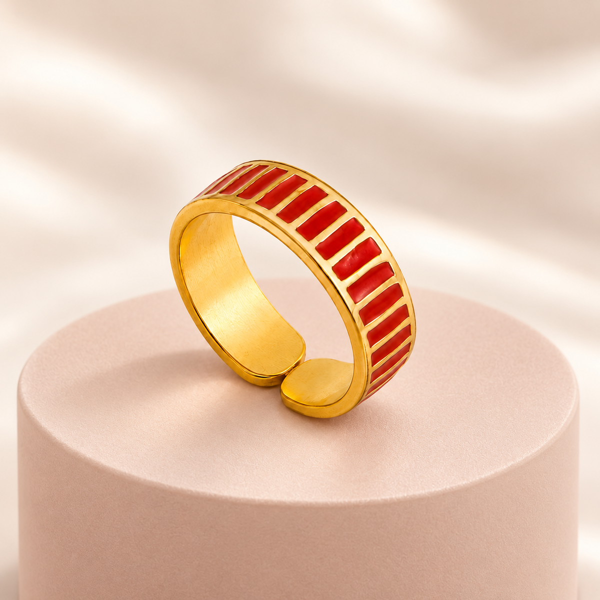 Gold-tone ring with red stripes, styled product view.