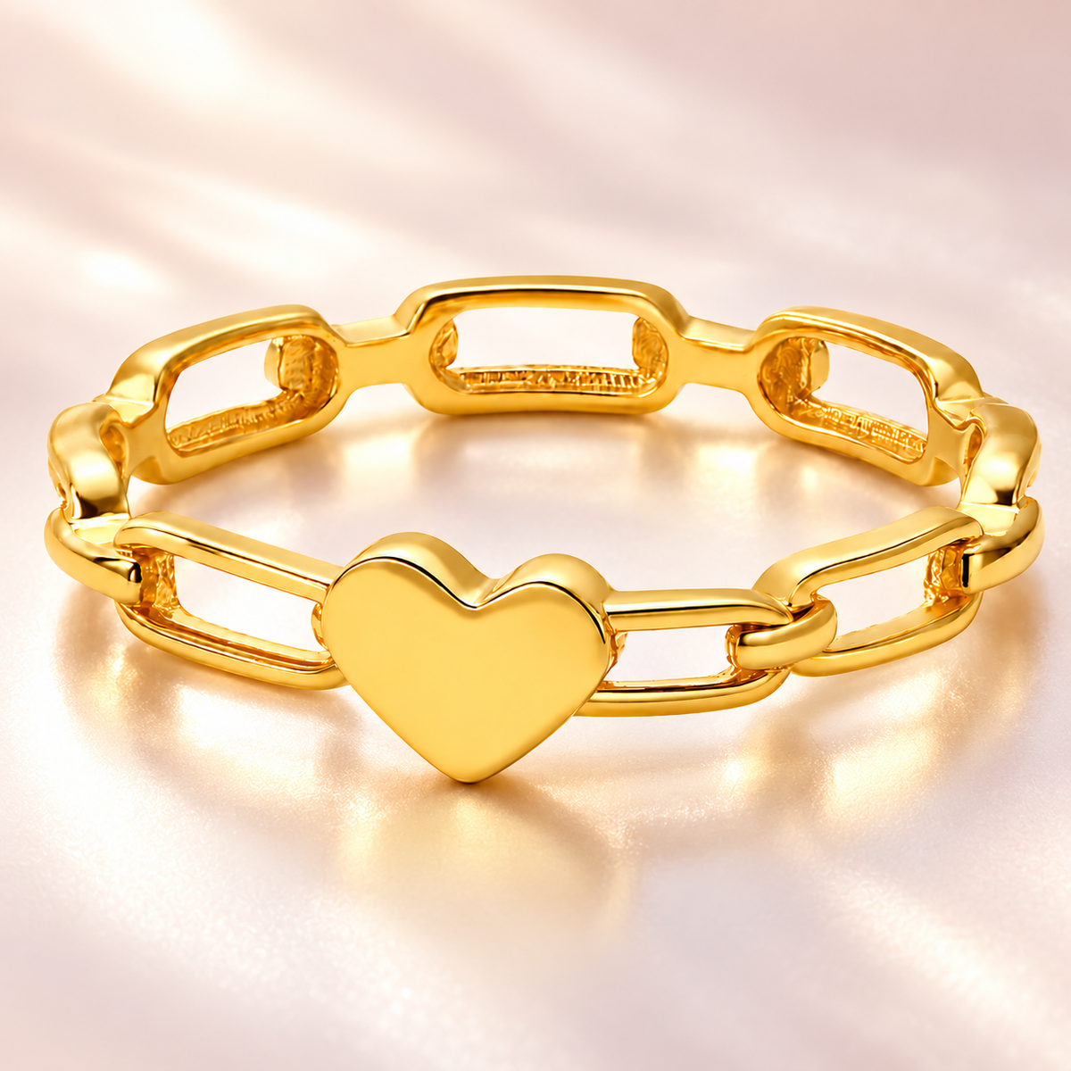 Gold-tone heart link ring, close-up view.