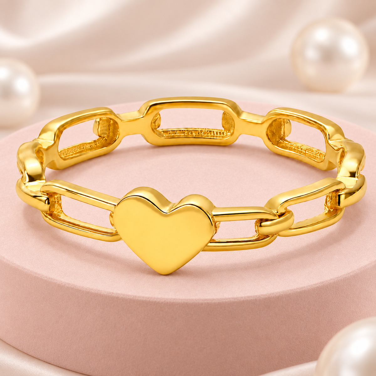 Gold-tone heart link ring, styled product view.