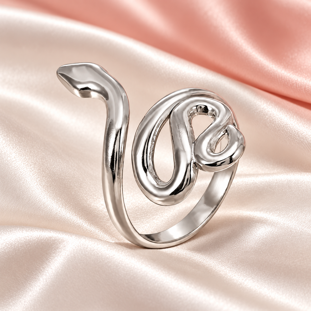 Silver-tone snake ring, still-life view on fabric.