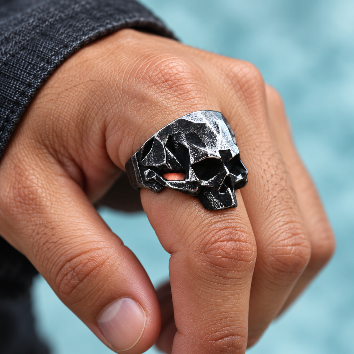 Angular Skull Ring shown on a hand.