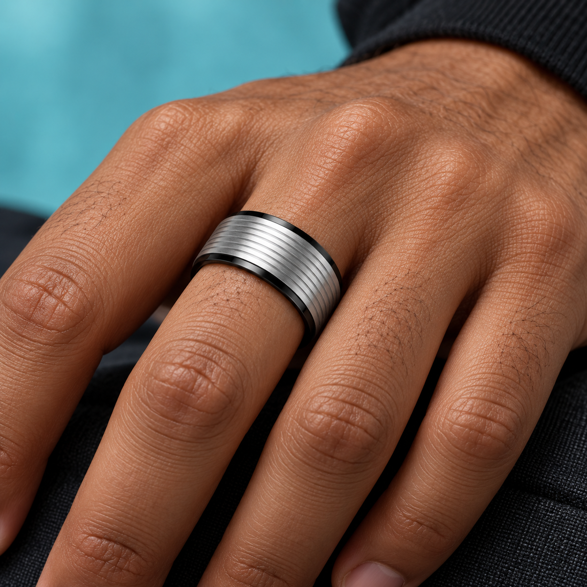 Black and Silver-Tone Grooved Band shown on a hand.